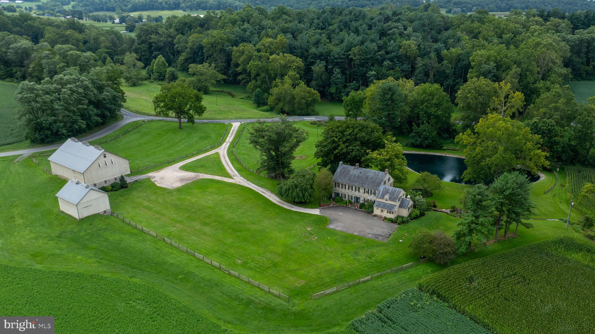 an aerial view of a house with pool yard and outdoor seating