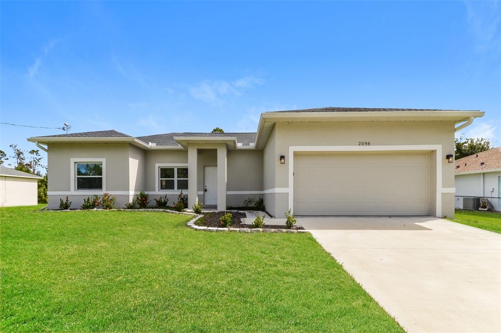 a front view of a house with a garden and yard