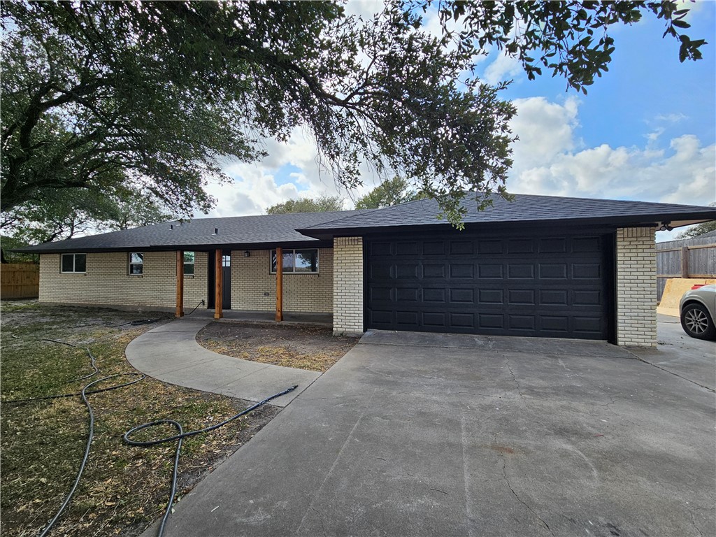 a front view of a house with yard space and garage