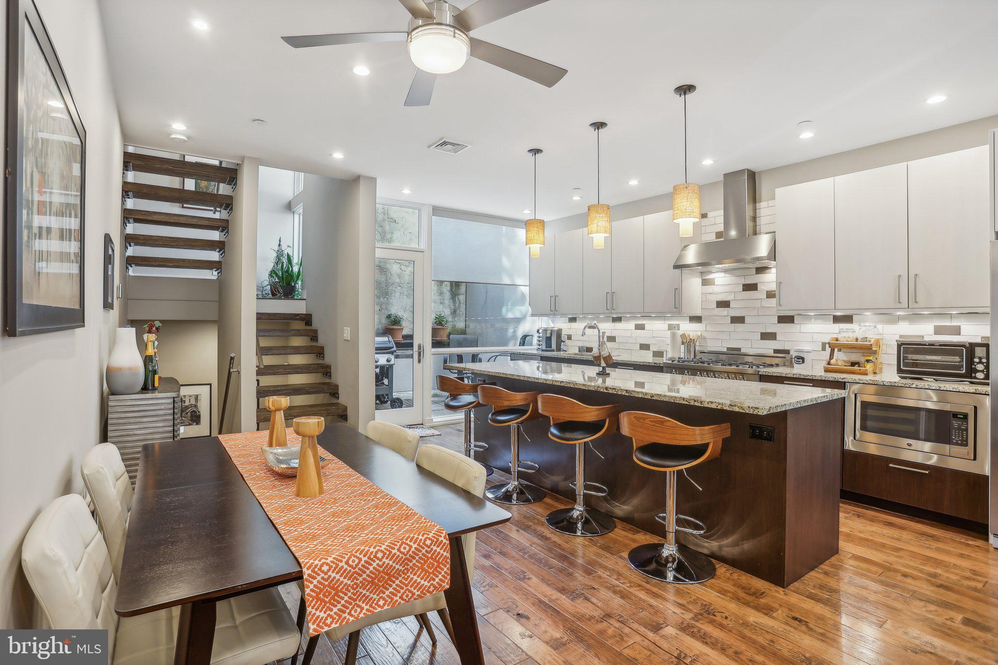 a large kitchen with a table and chairs