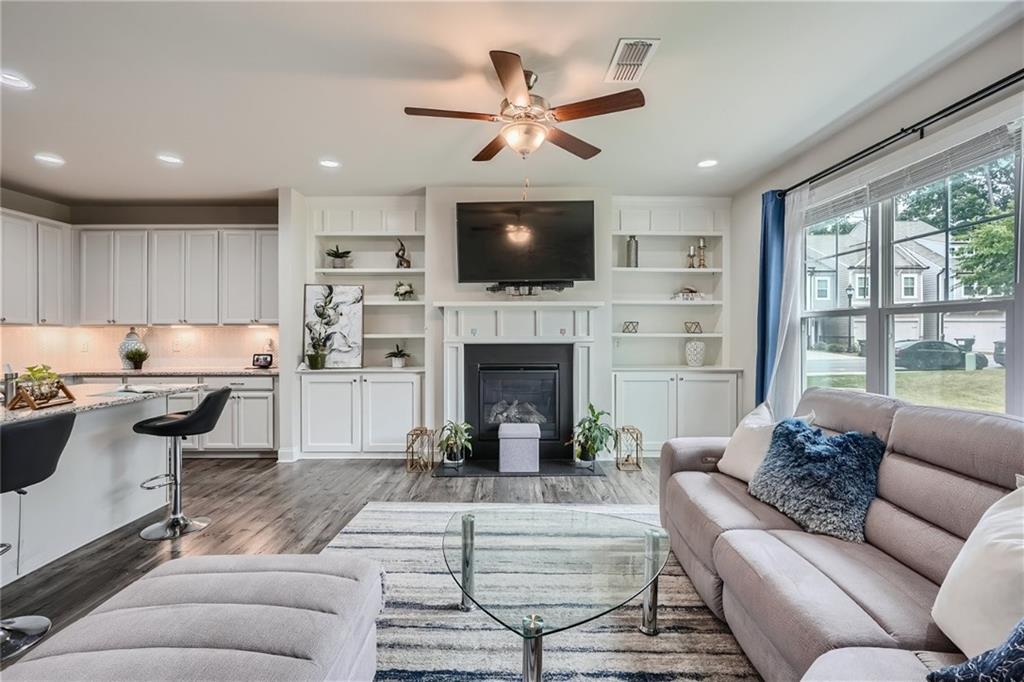 a living room with furniture fireplace and a flat screen tv