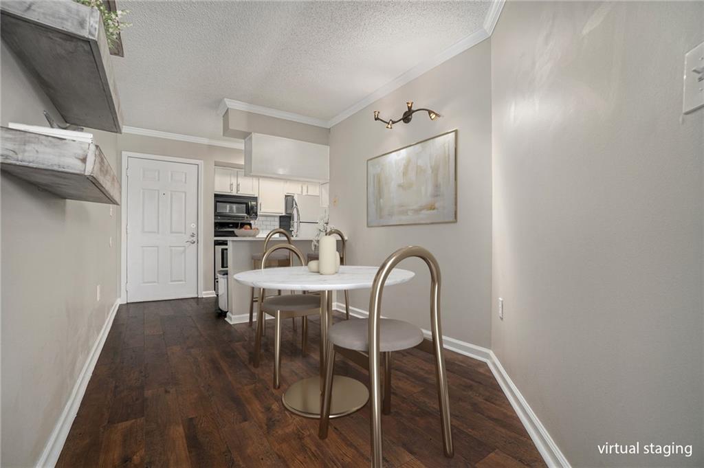 a kitchen with stainless steel appliances a dining table and chairs