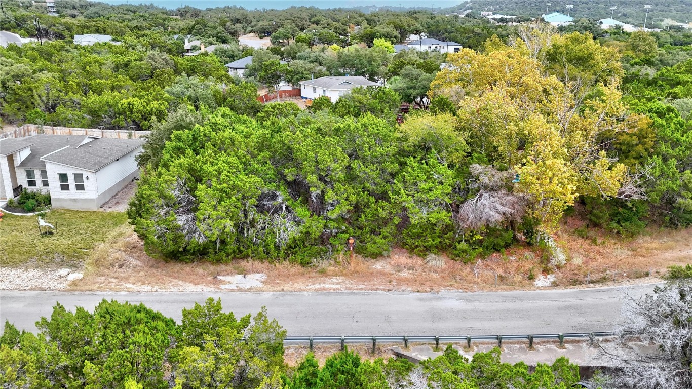 an aerial view of residential house with yard and outdoor seating