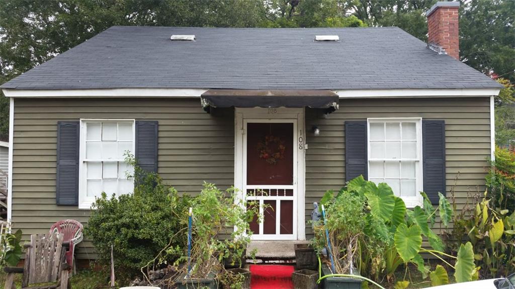 a aerial view of a house with a yard and potted plants