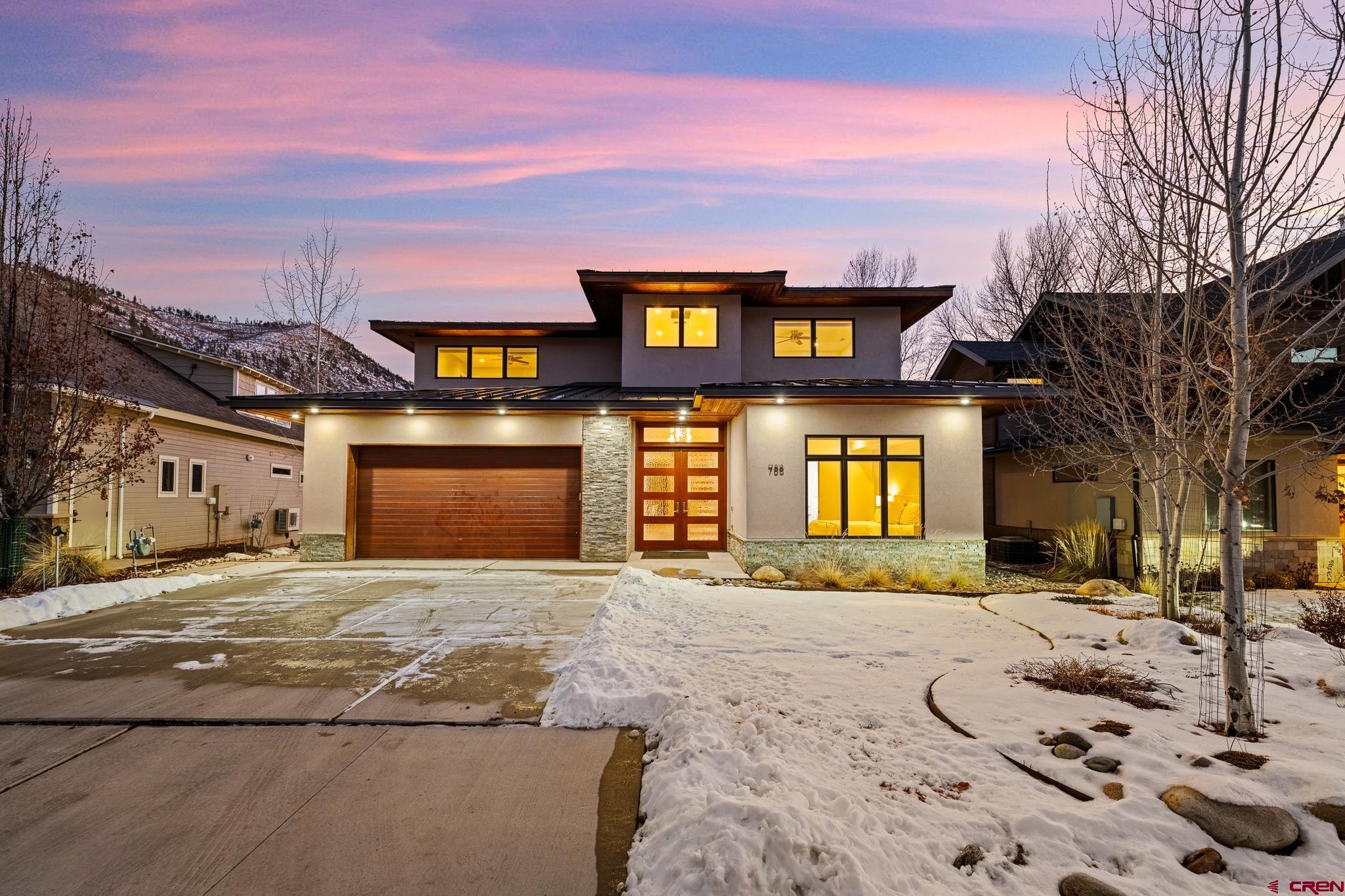 a front view of a brick house with a yard