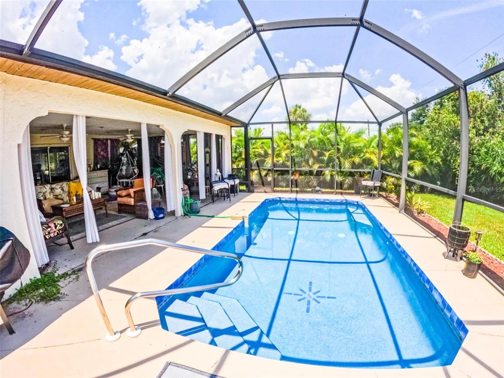 a view of swimming pool with seating area