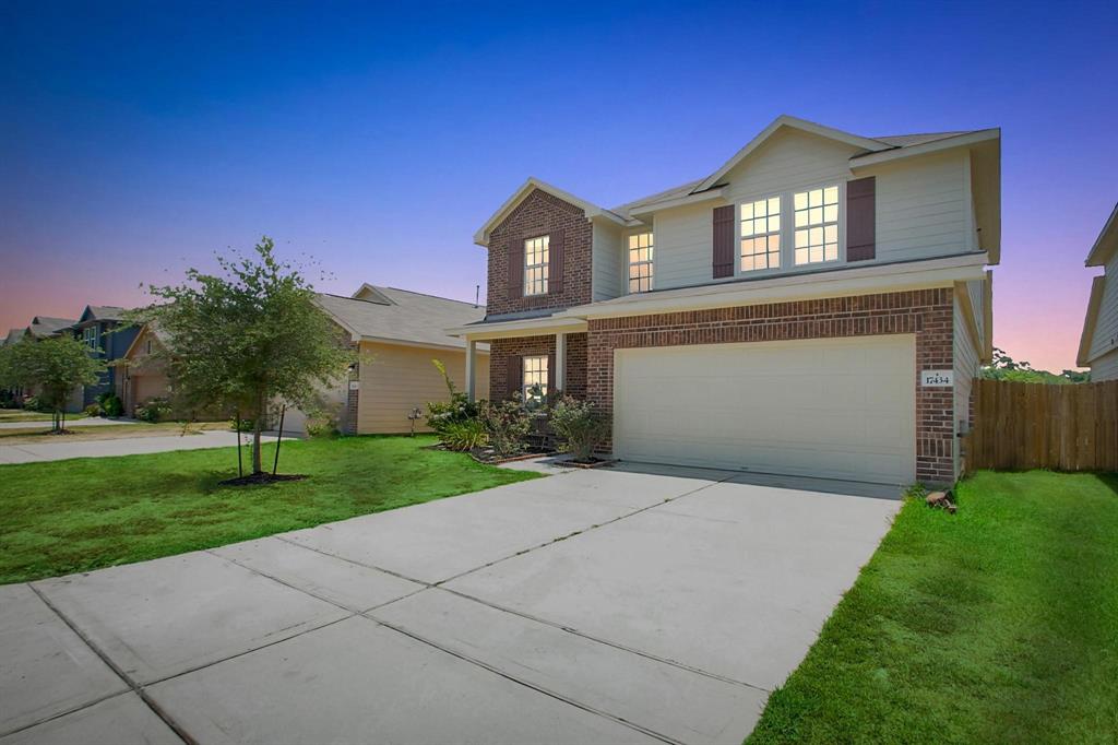 a front view of a house with a yard and garage