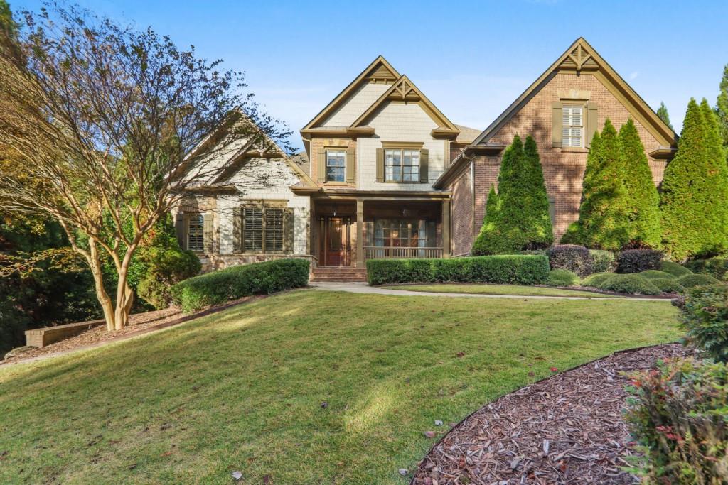 a front view of a house with yard and green space