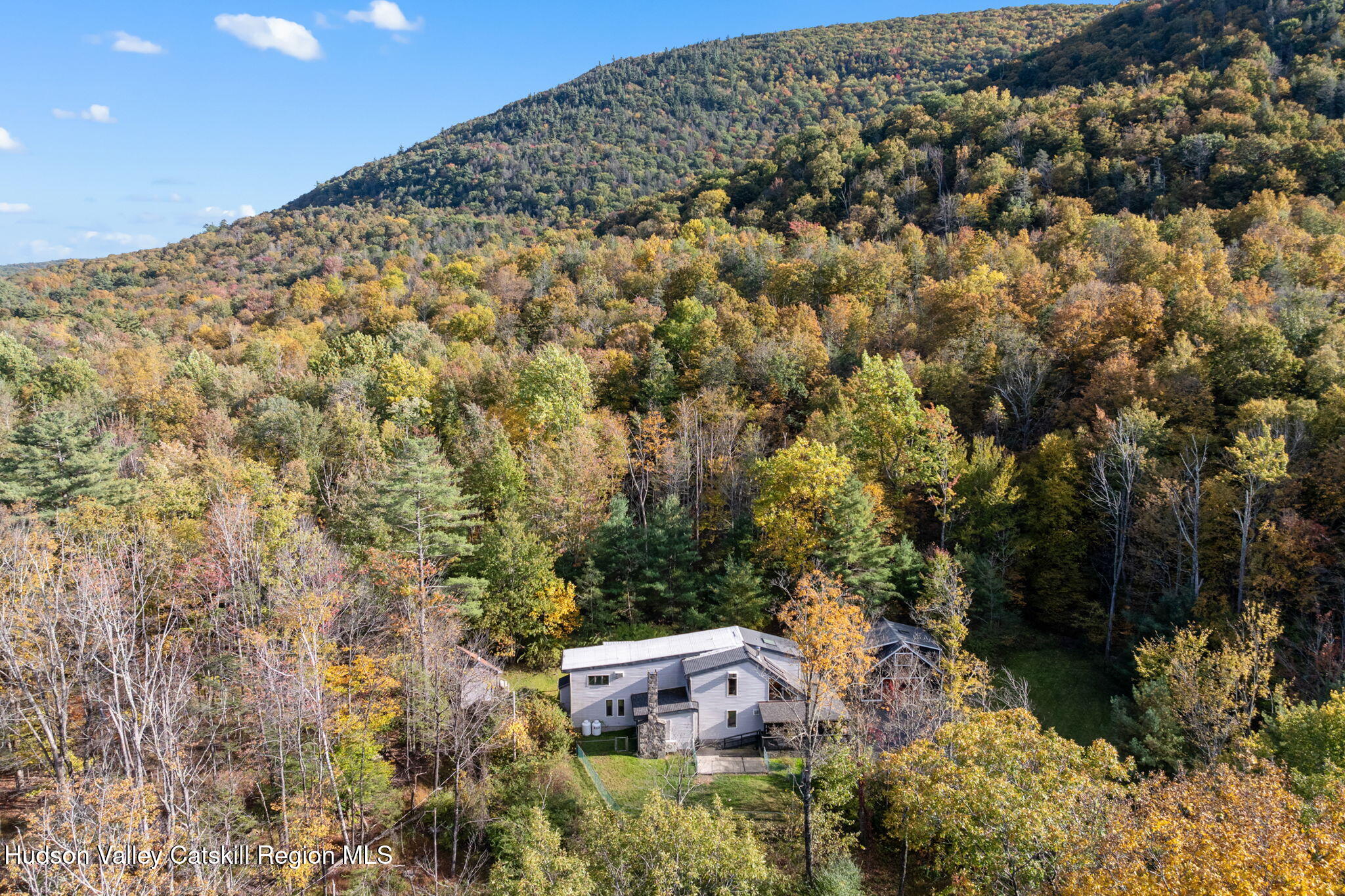 an aerial view of a house with a yard