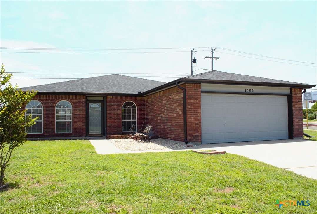 a front view of a house with yard and garage