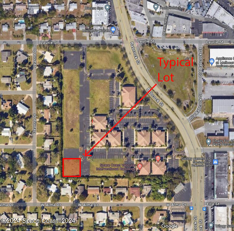 an aerial view of multi story residential apartment building with parking