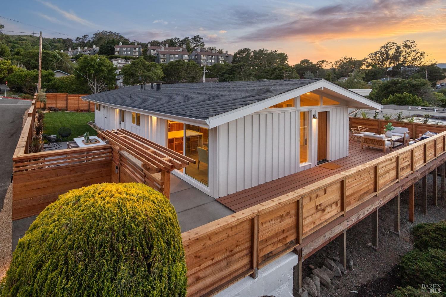 a view of a house with wooden fence