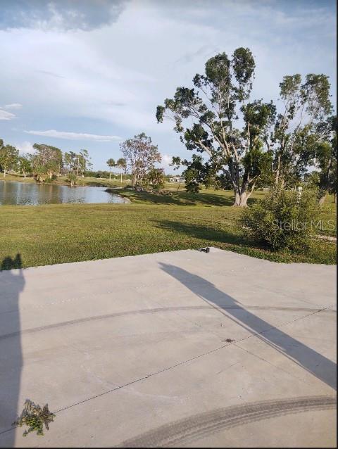 an aerial view of a house with a yard and lake view