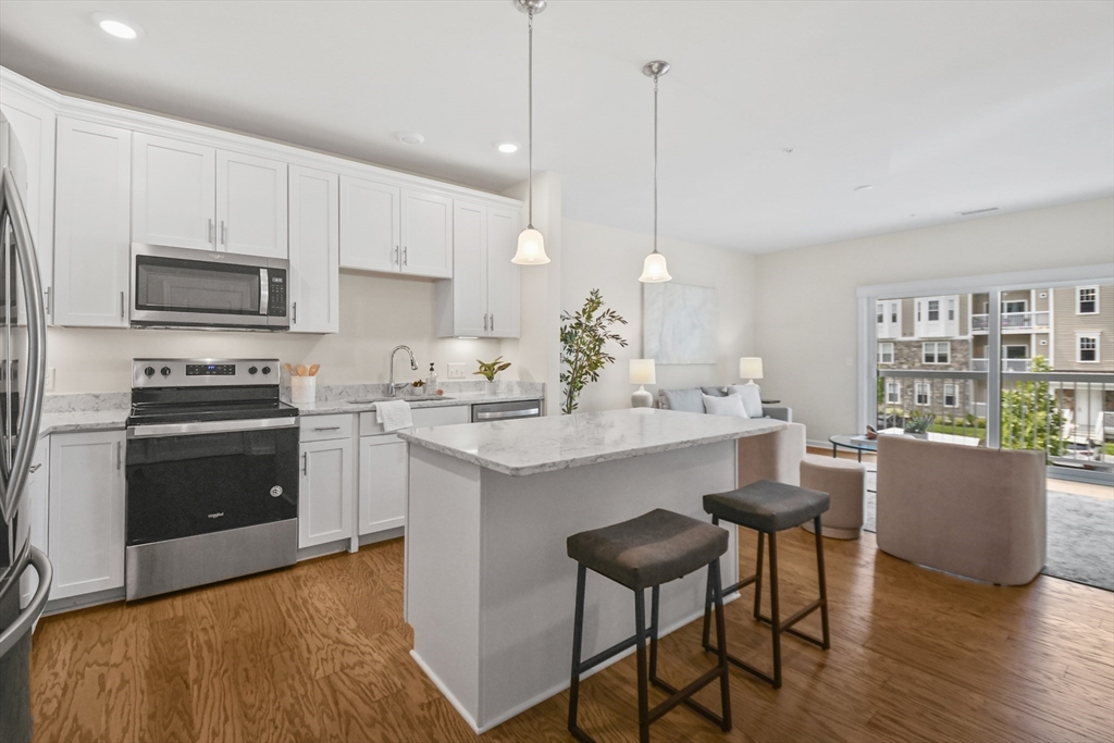 a kitchen with a sink a microwave a stove and refrigerator