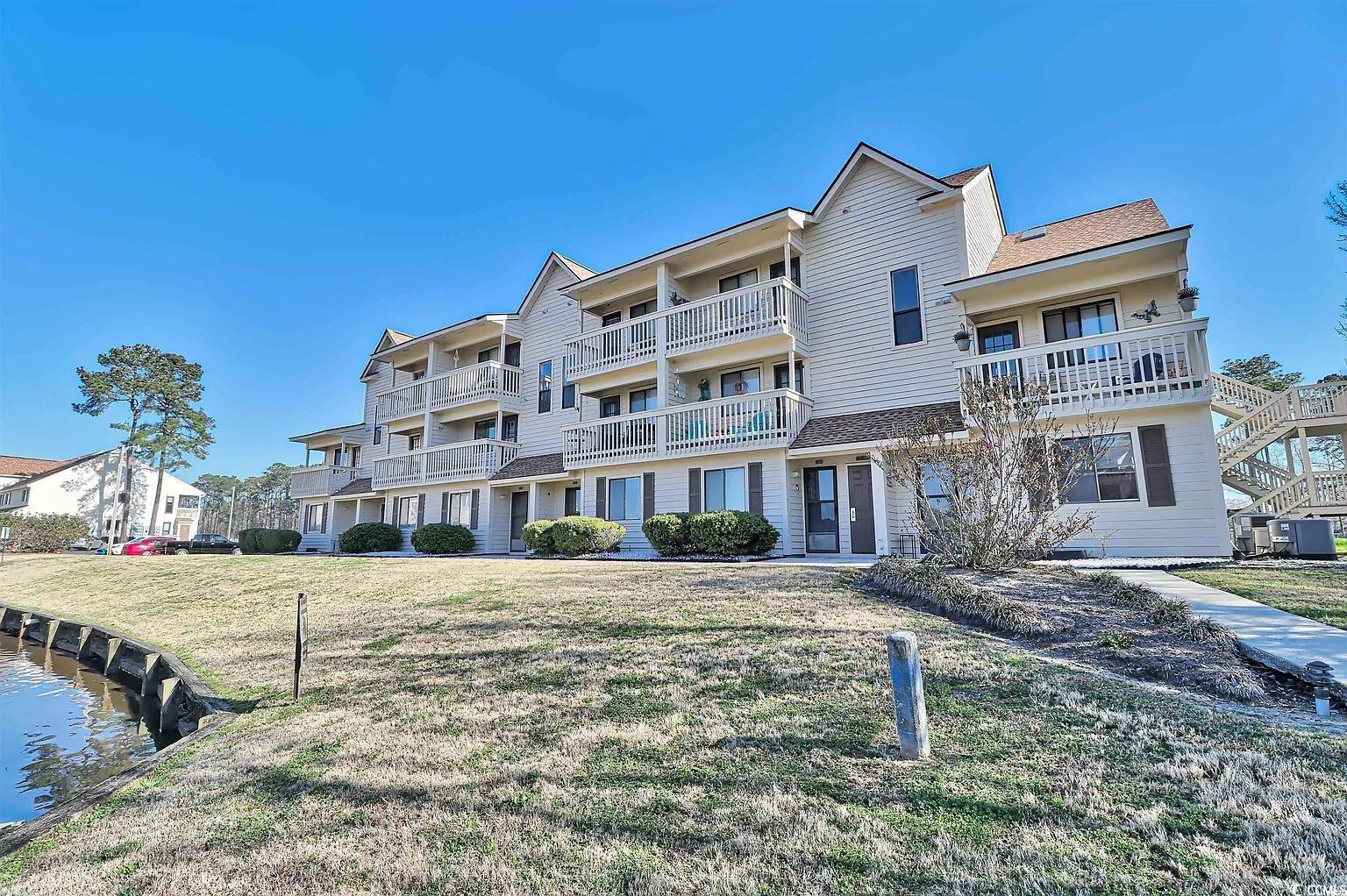 Exterior space featuring a balcony, a front lawn,