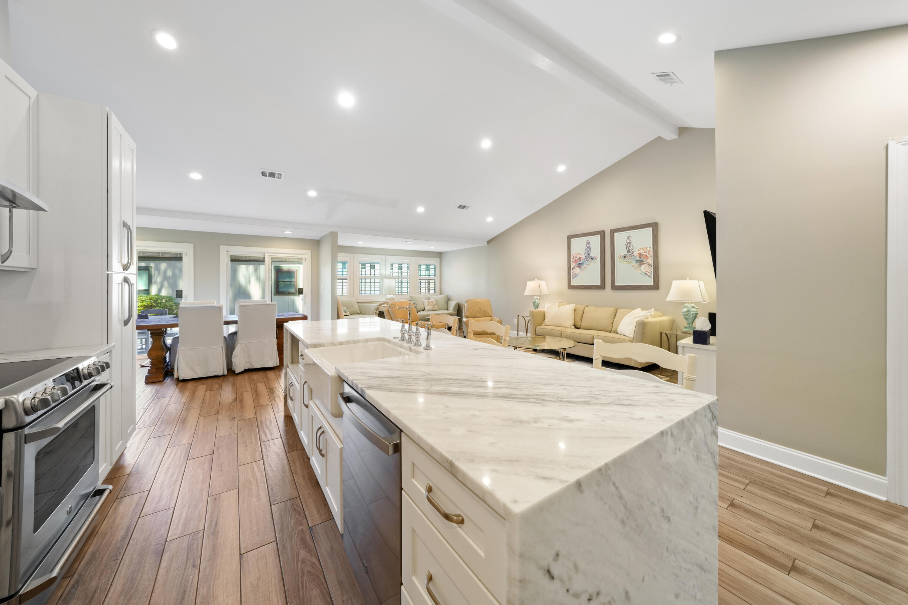 a large white kitchen with sink stove and refrigerator