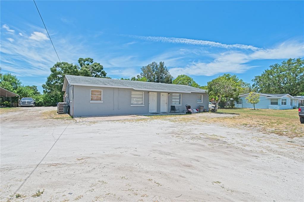 a view of a house with a yard and a garage