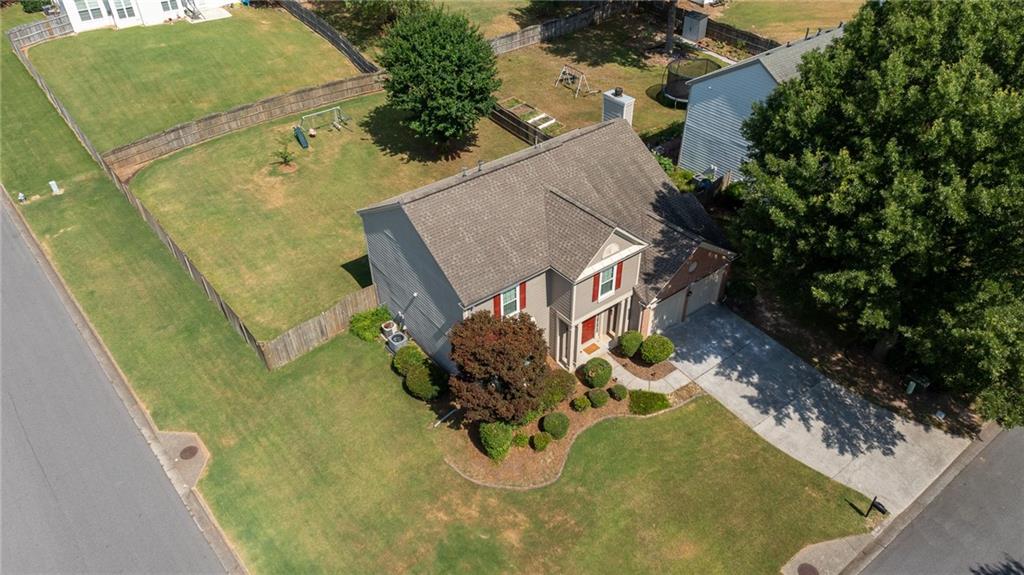 an aerial view of a house with a yard