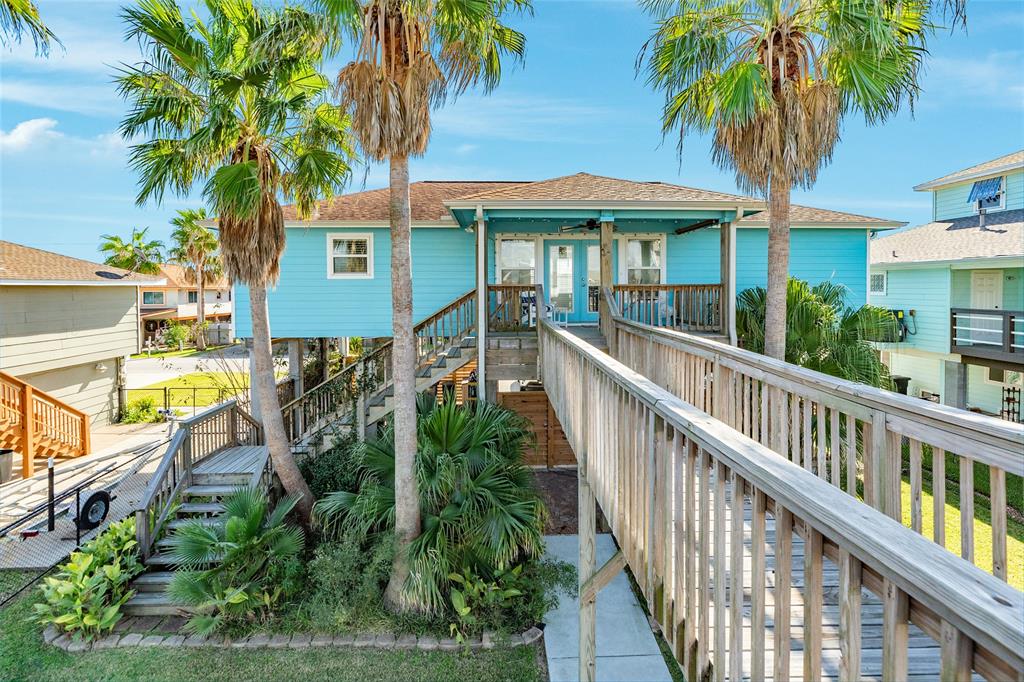 a view of a house with balcony and wooden floor