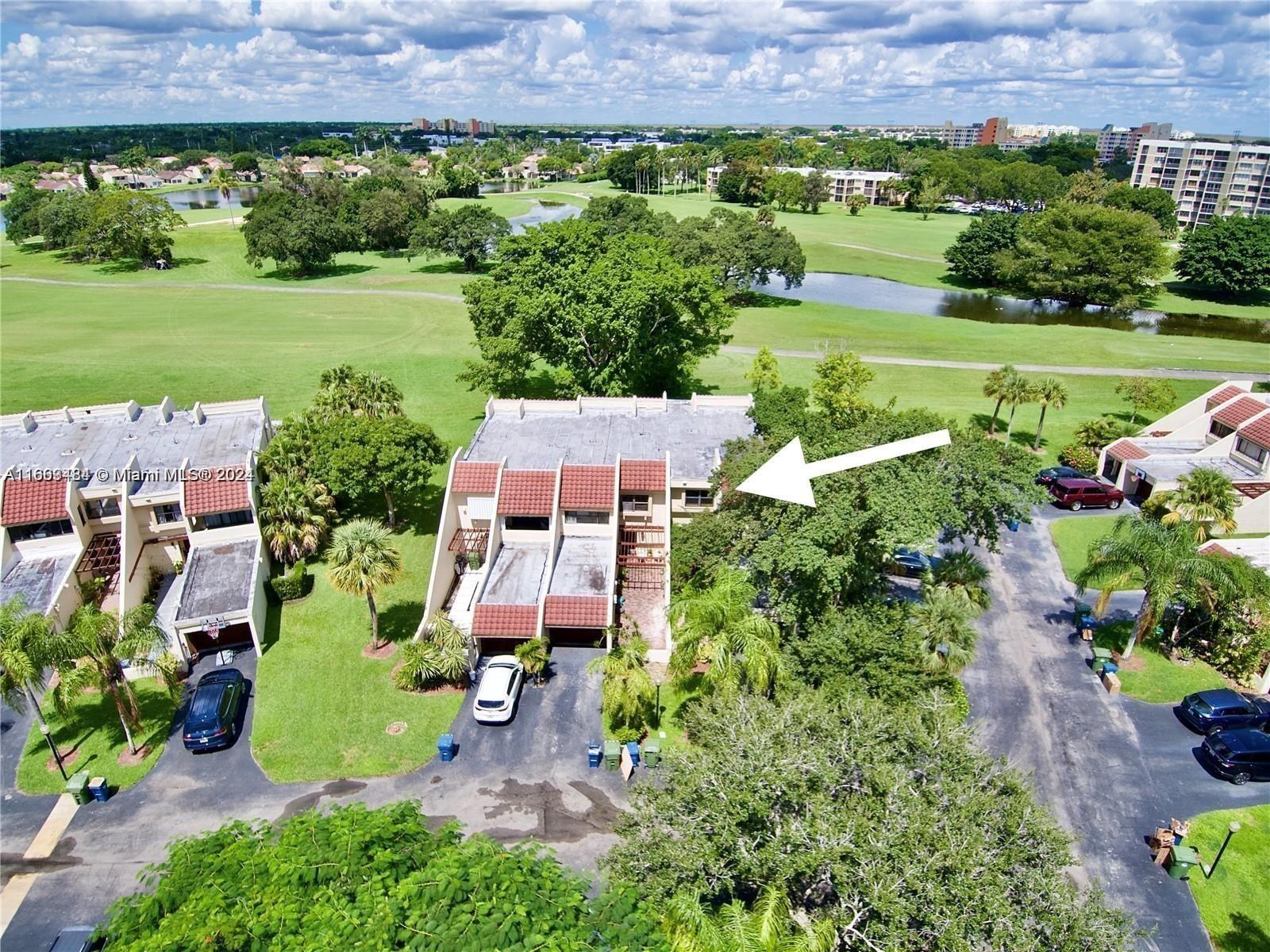 an aerial view of a house with outdoor space and a garden