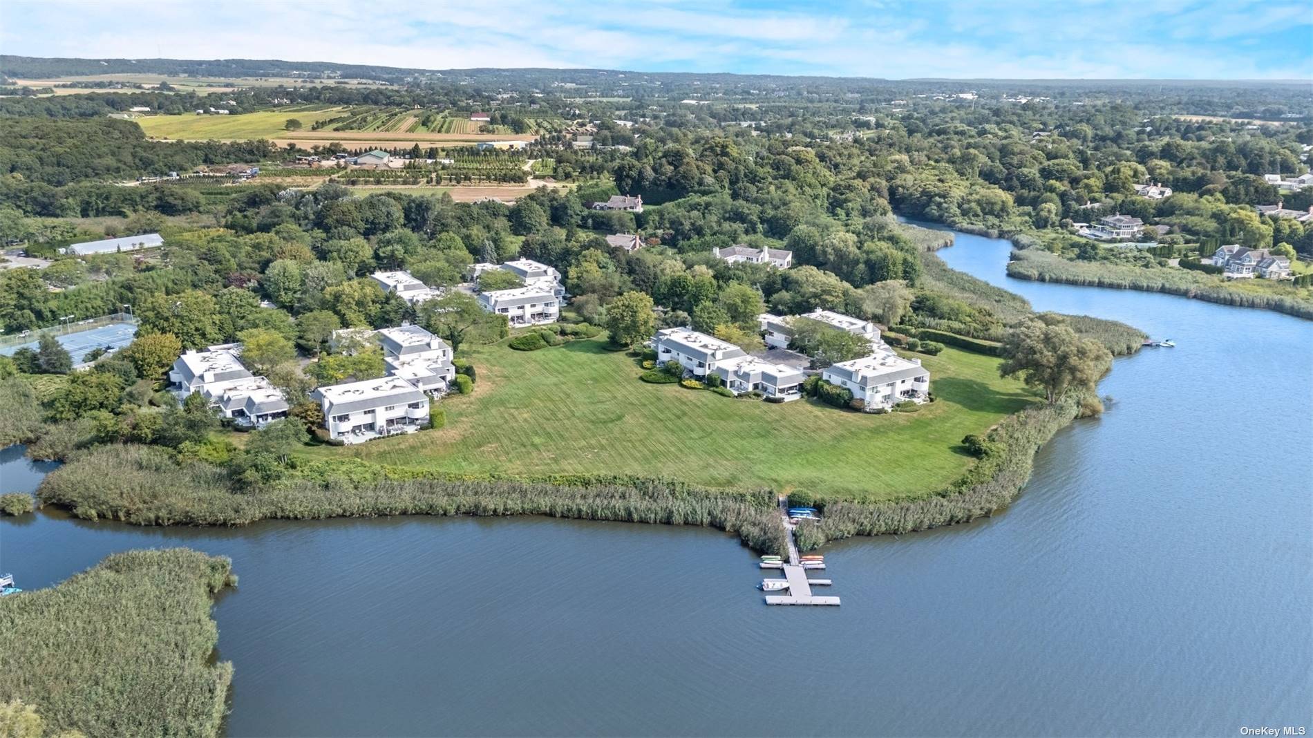 an aerial view of a residential houses with outdoor space and pool