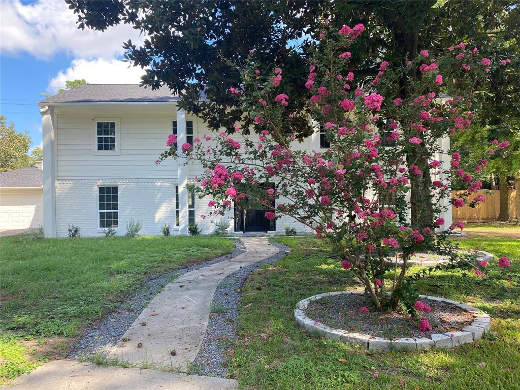 a front view of a house with a yard and fountain