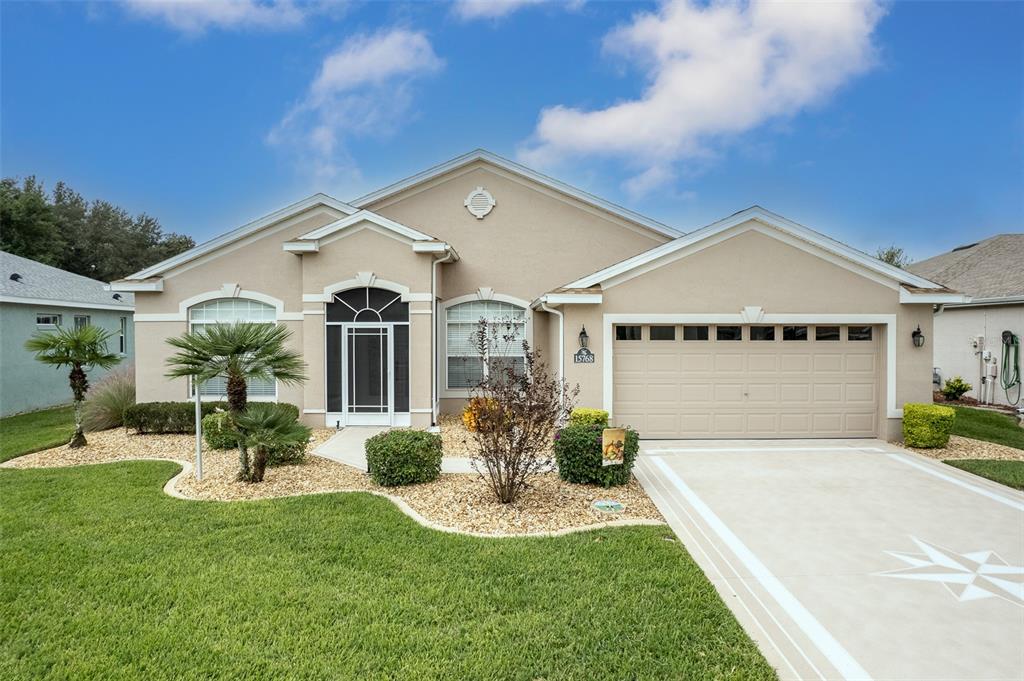 a front view of a house with a yard fire pit and outdoor seating