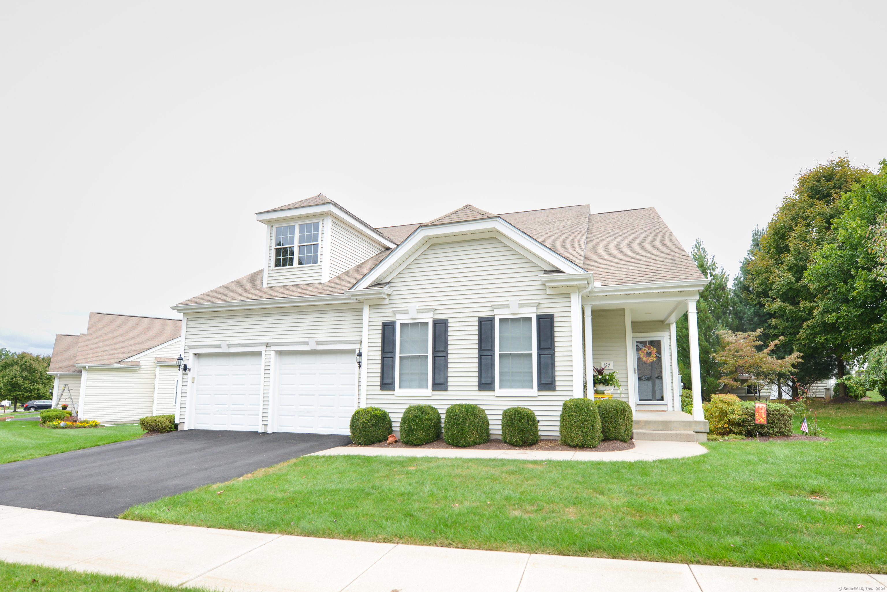 a view of a house with a yard and pathway