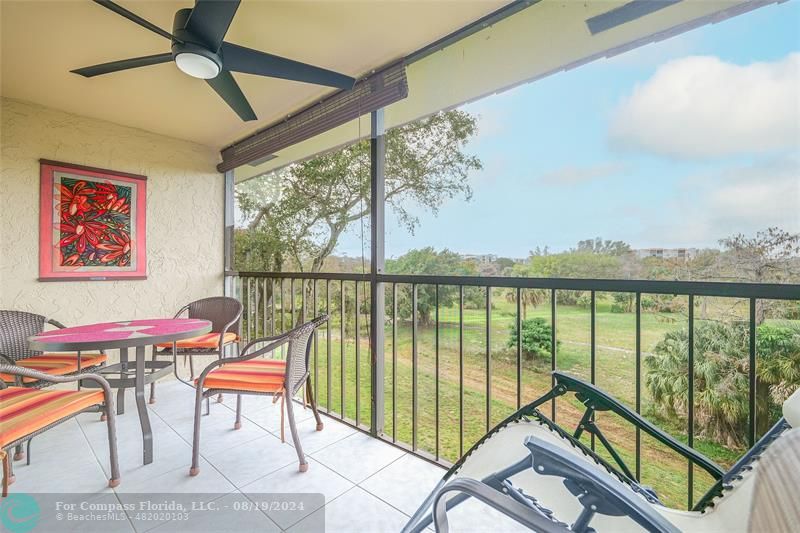 a balcony with furniture and a large window