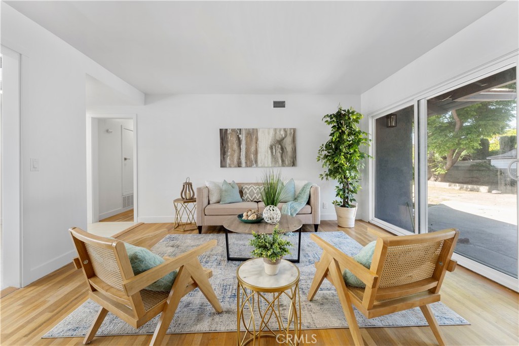 a dining room with furniture and wooden floor