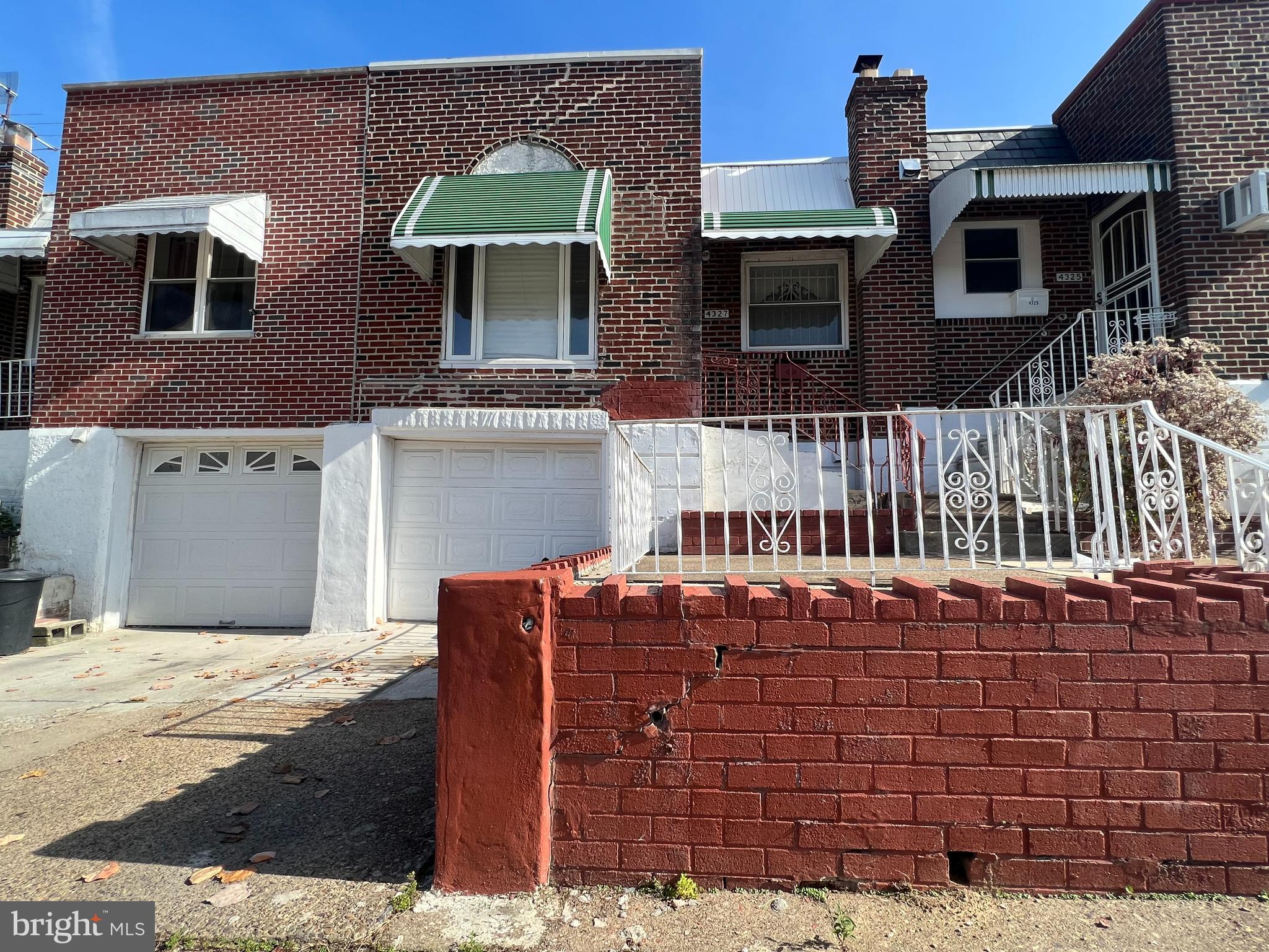 a front view of house with a garden