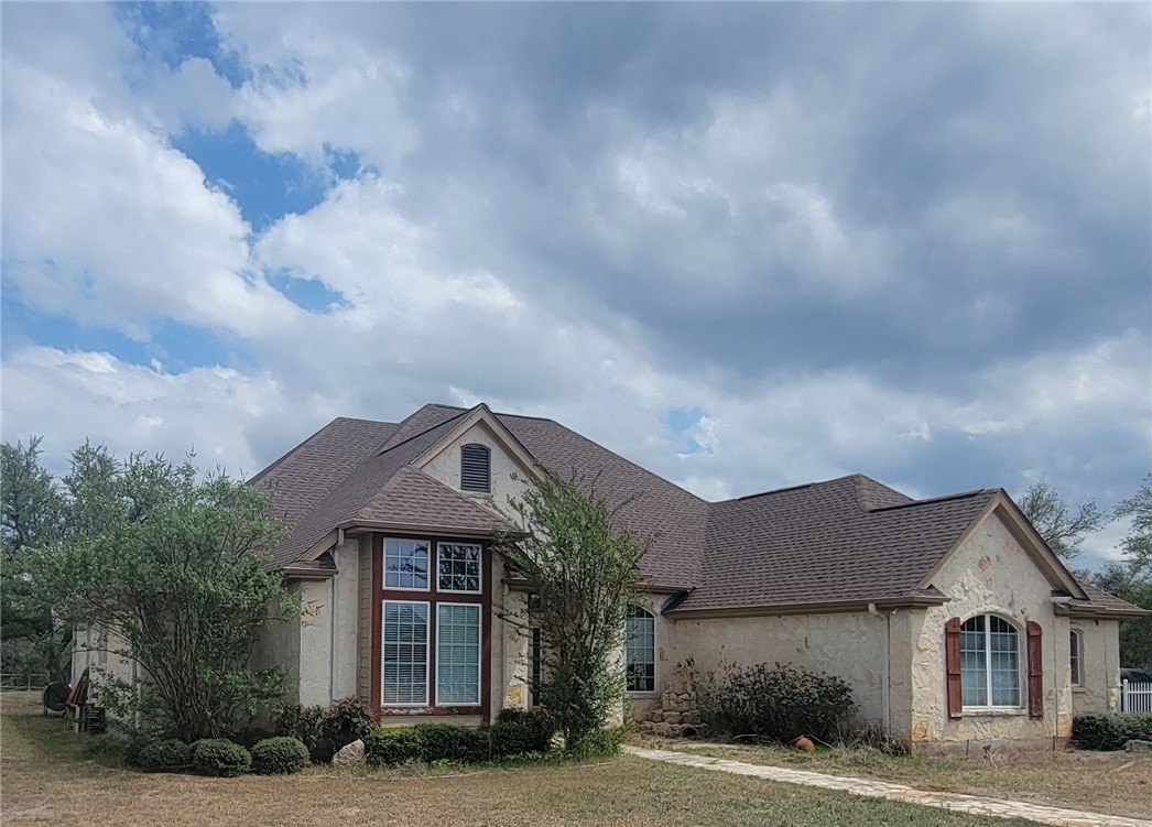 a front view of a house with a garden