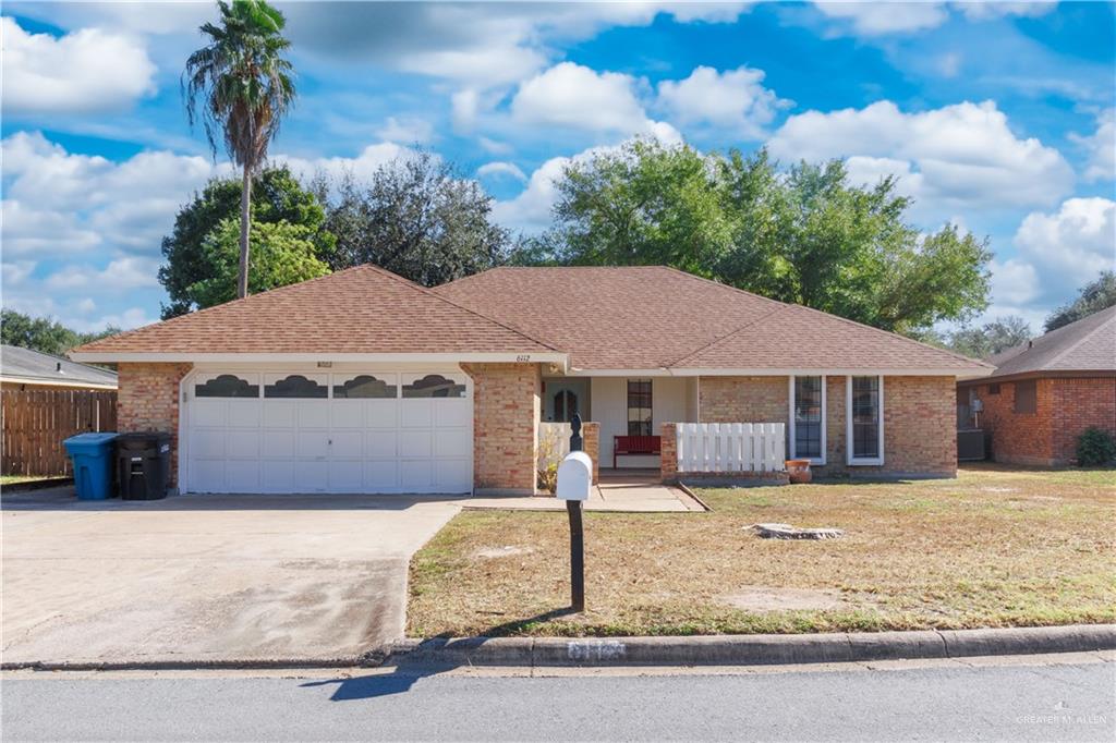 Ranch-style home featuring central AC, covered porch, a front yard, and a garage