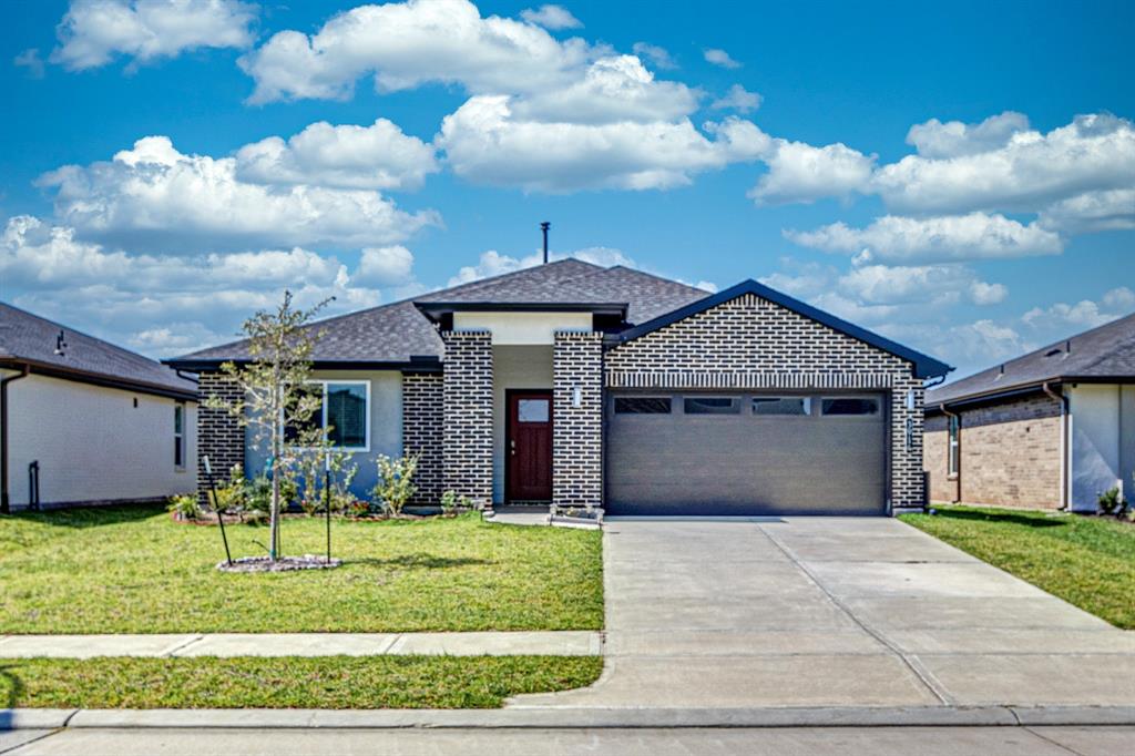 a front view of a house with a yard and entertaining space