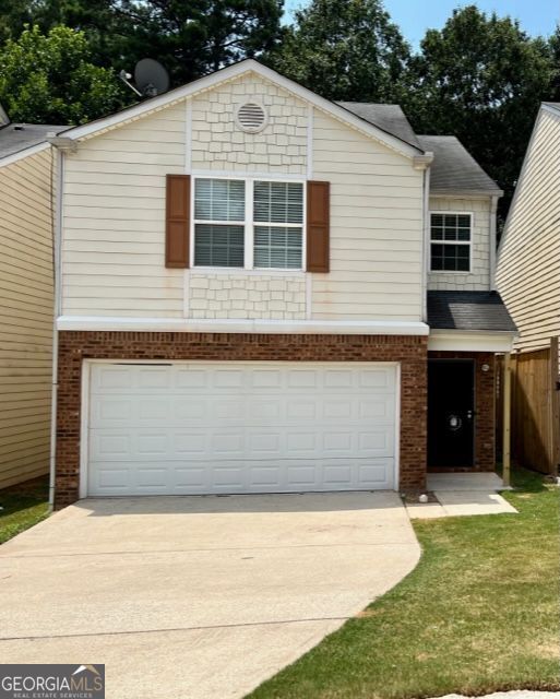 a front view of a house with a yard