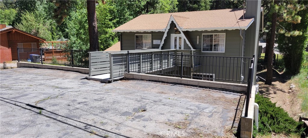 a view of a house with a wooden fence