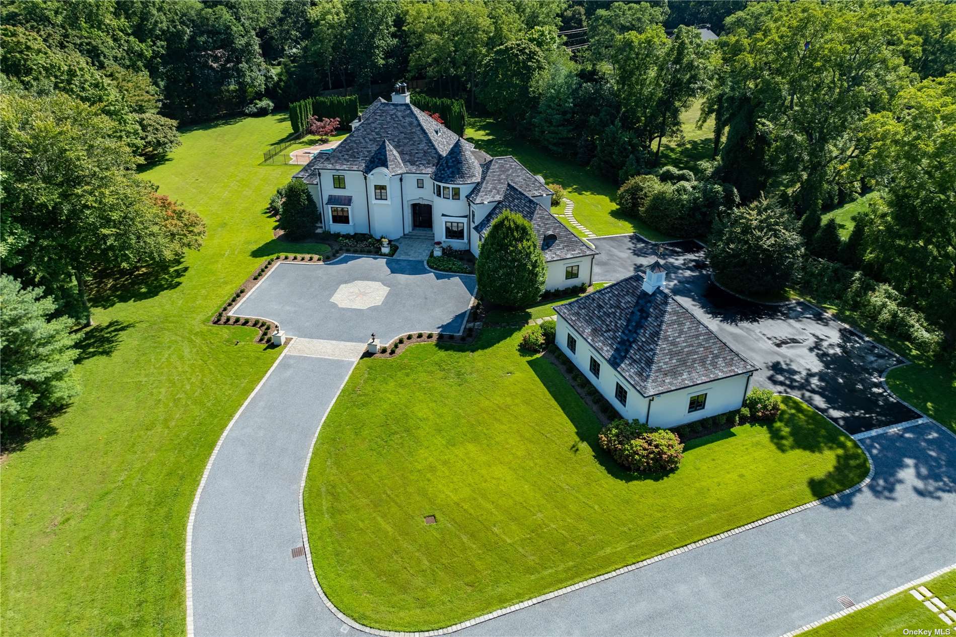 an aerial view of a house with swimming pool and big yard