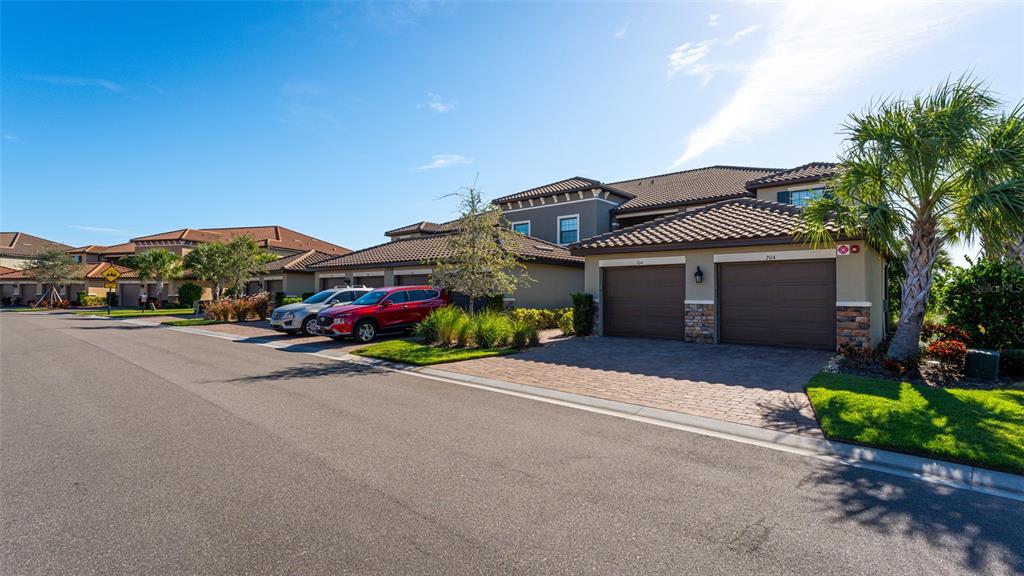 a front view of a house with a yard and parking space