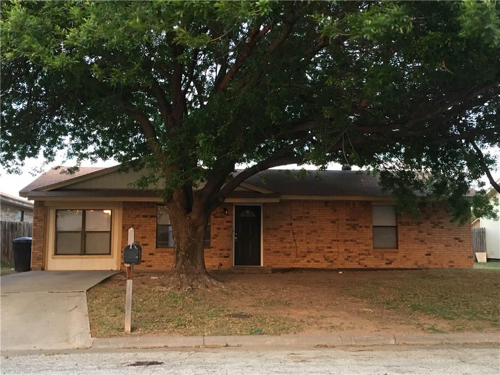 front view of a house with a tree