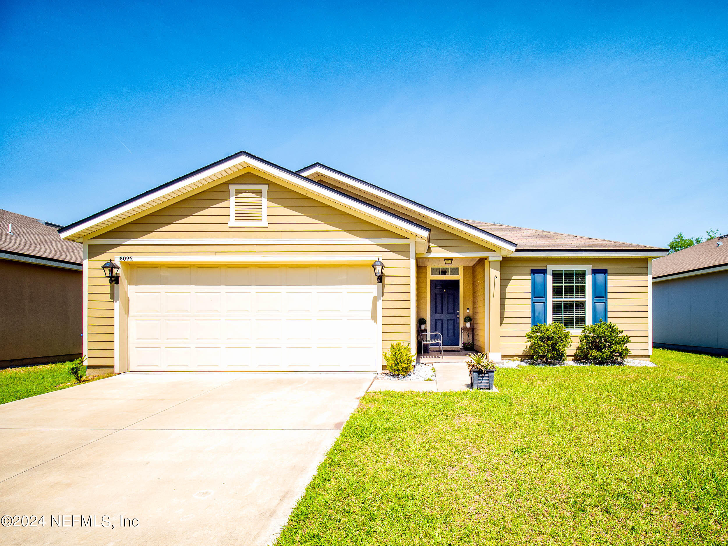 a front door view of a house with a yard