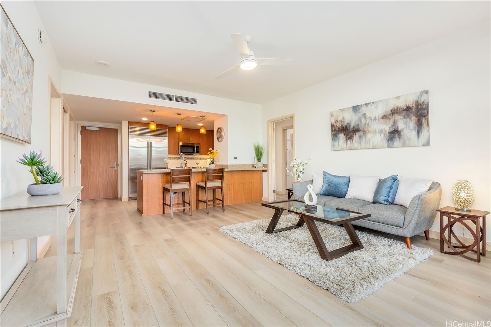 a living room with furniture and a table with chair