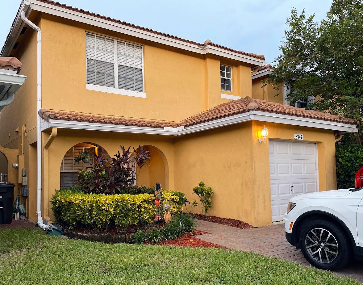 a front view of a house with garden