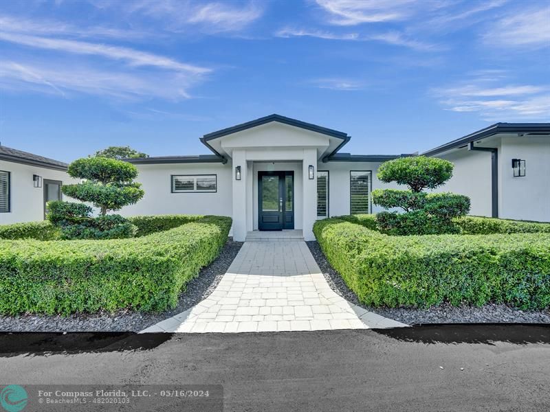 front view of a house with a garden