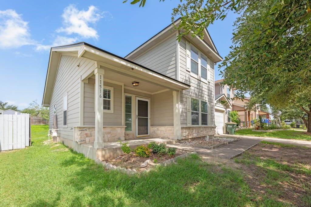 a front view of a house with a garden