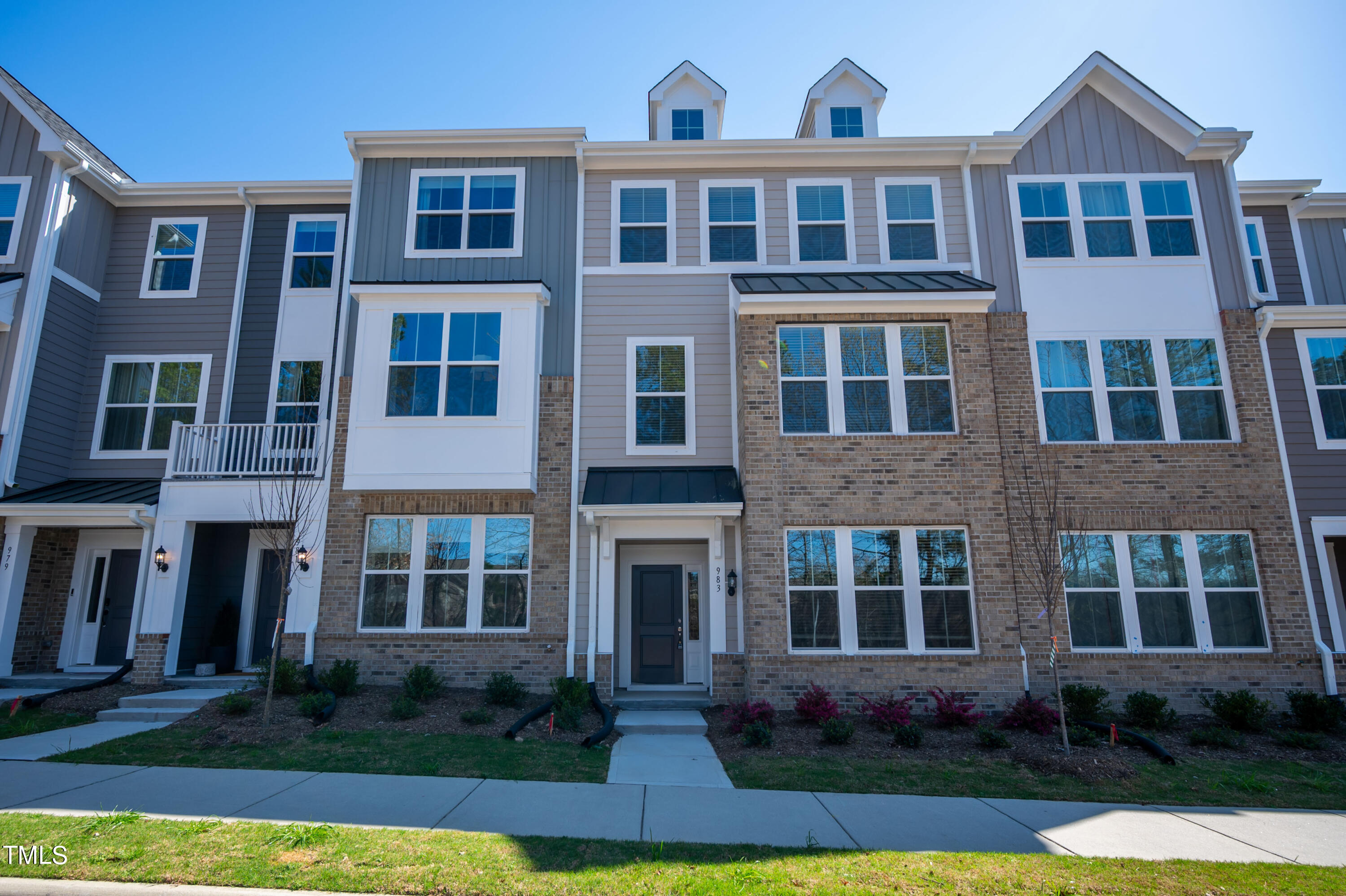 a front view of a residential apartment building with a yard