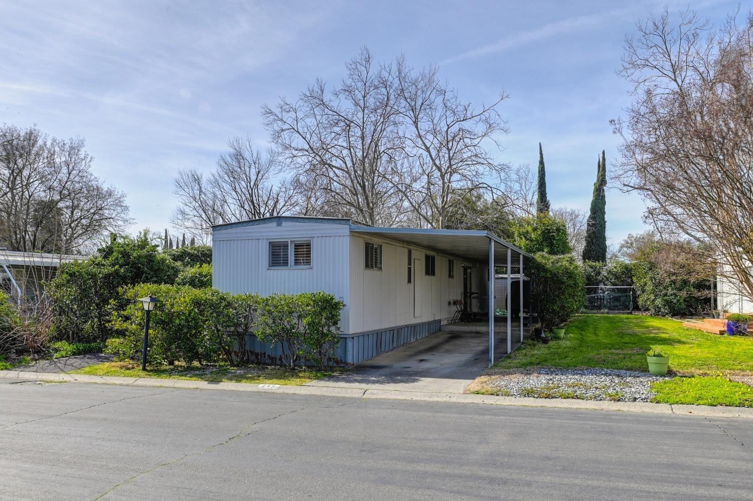 a view of a house with a yard and plants