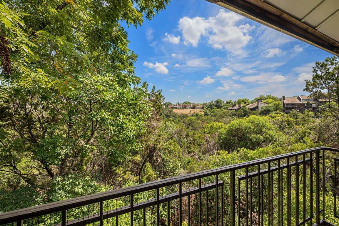 a view of a balcony with a tree