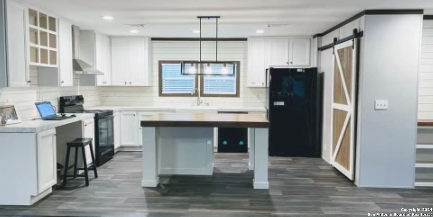 a kitchen with a refrigerator and a sink