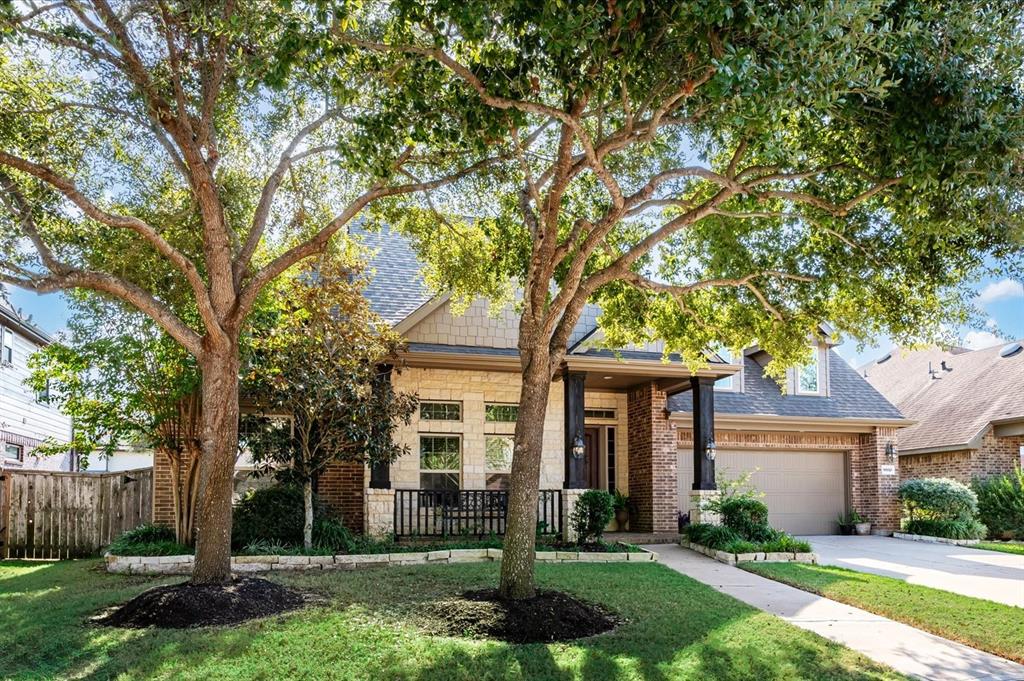 Towering oaks embrace this Hill Country themed home in the highly desired Pine Hills section of Cinco Ranch Southwest.