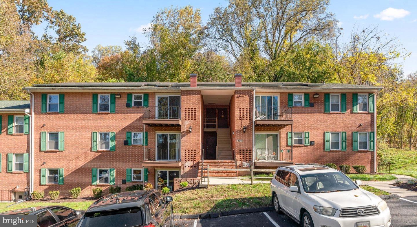 front view of a brick house with a yard